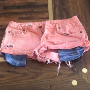 Pink booty shorts with blue stripped pockets